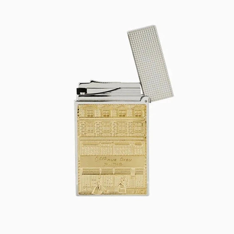 A gold and white S.T. Dupont Line 2 Hotel Particulier Lighter with a design on it.