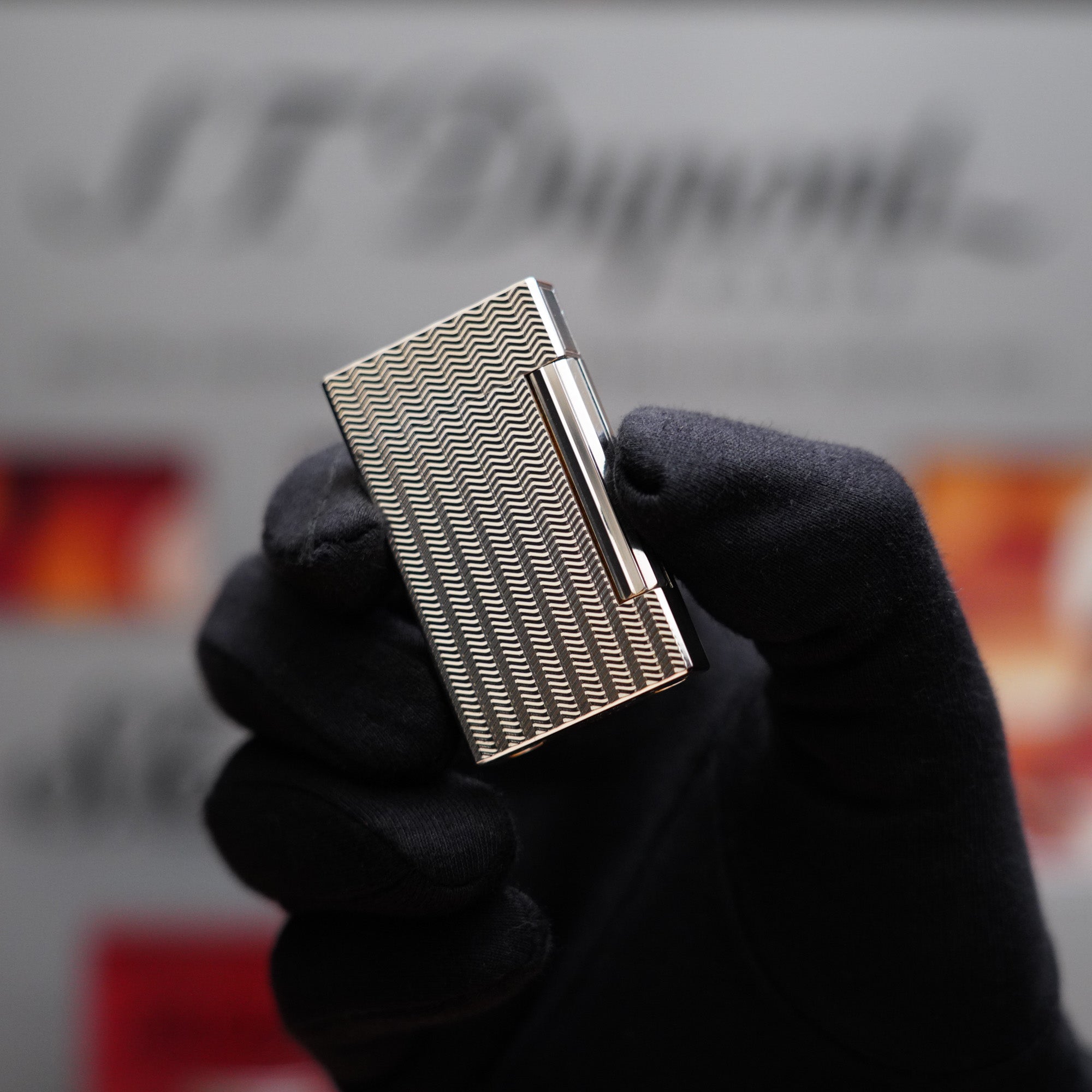 A person is holding a Vintage 1980 St Dupont Ligne D Heavy Silver Plated Lighter Fine Wave Type Lighter, possibly an S.T. Dupont, in their hand.