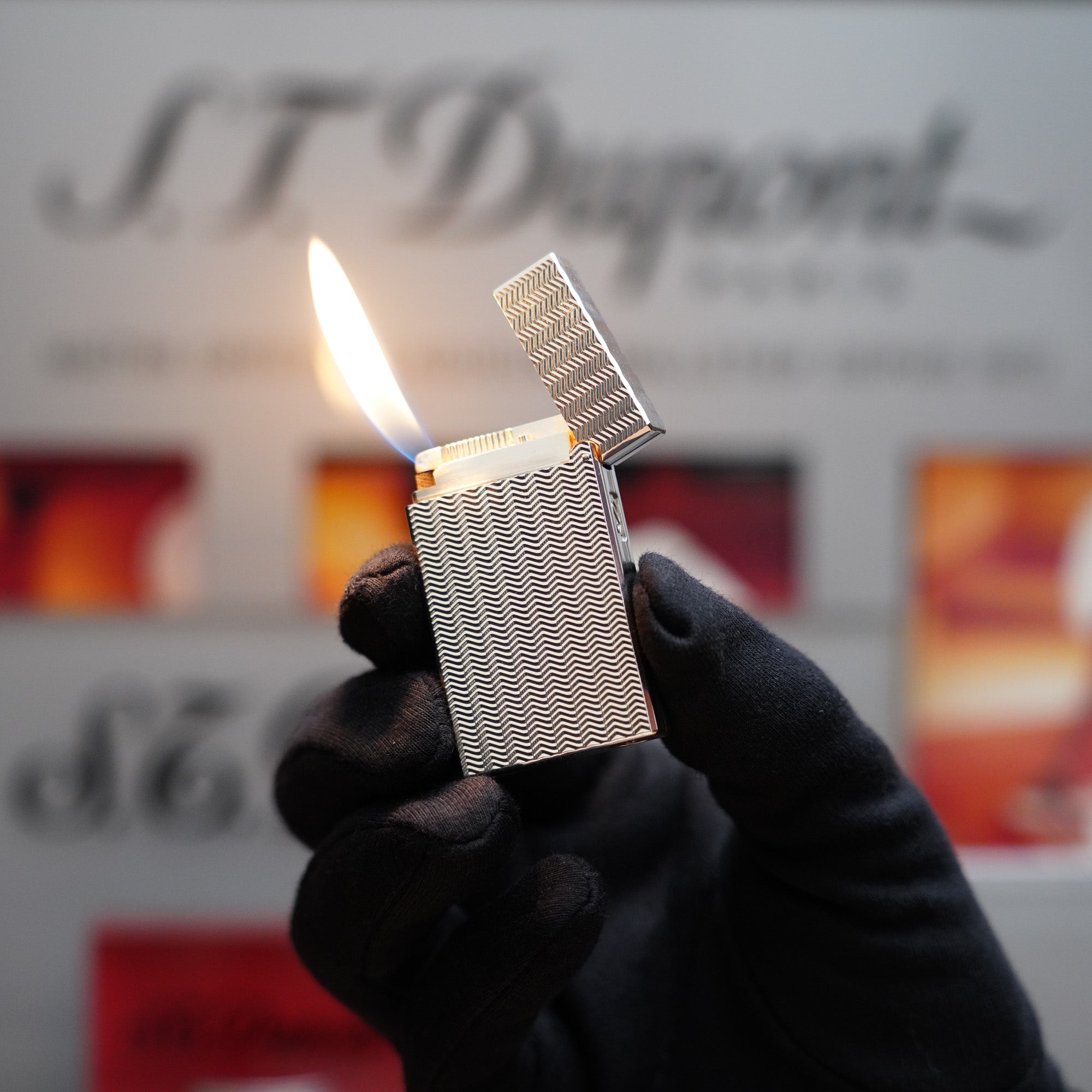 A Vintage 1980 S.T. Dupont Ligne D Heavy Silver Plated Lighter Fine Wave Type Lighter held by a person in front of a sign.