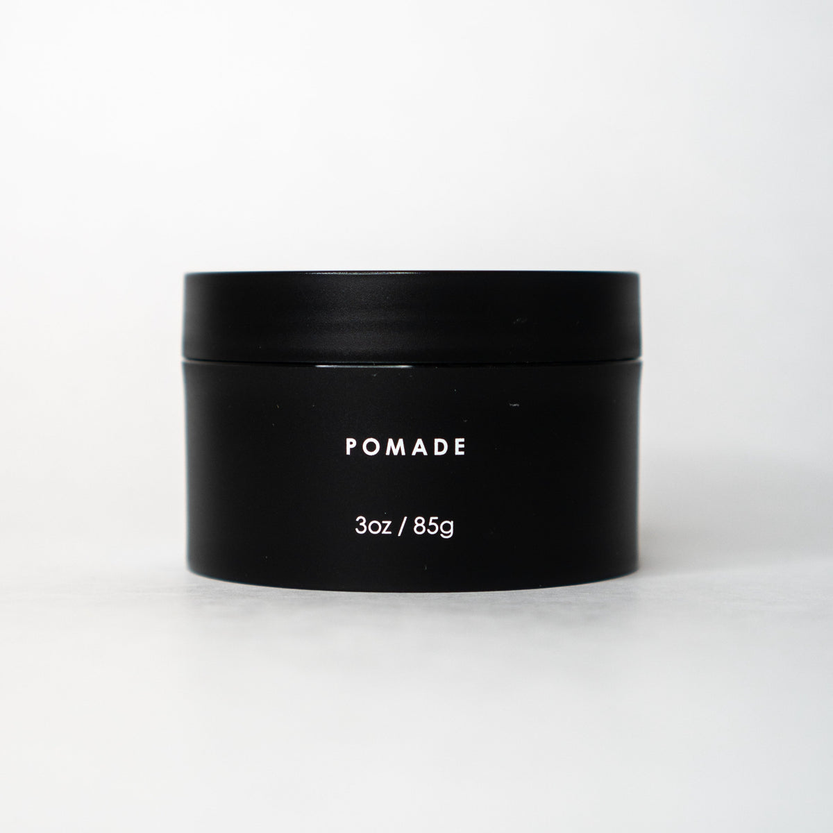 A nourished and healthy black jar of KirbyAllison.com Forte Series Pomade for high volume hairstyles.