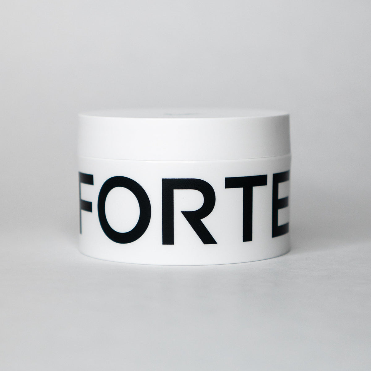 A jar of Forte Series Styling Cream by KirbyAllison.com with a satin finish.