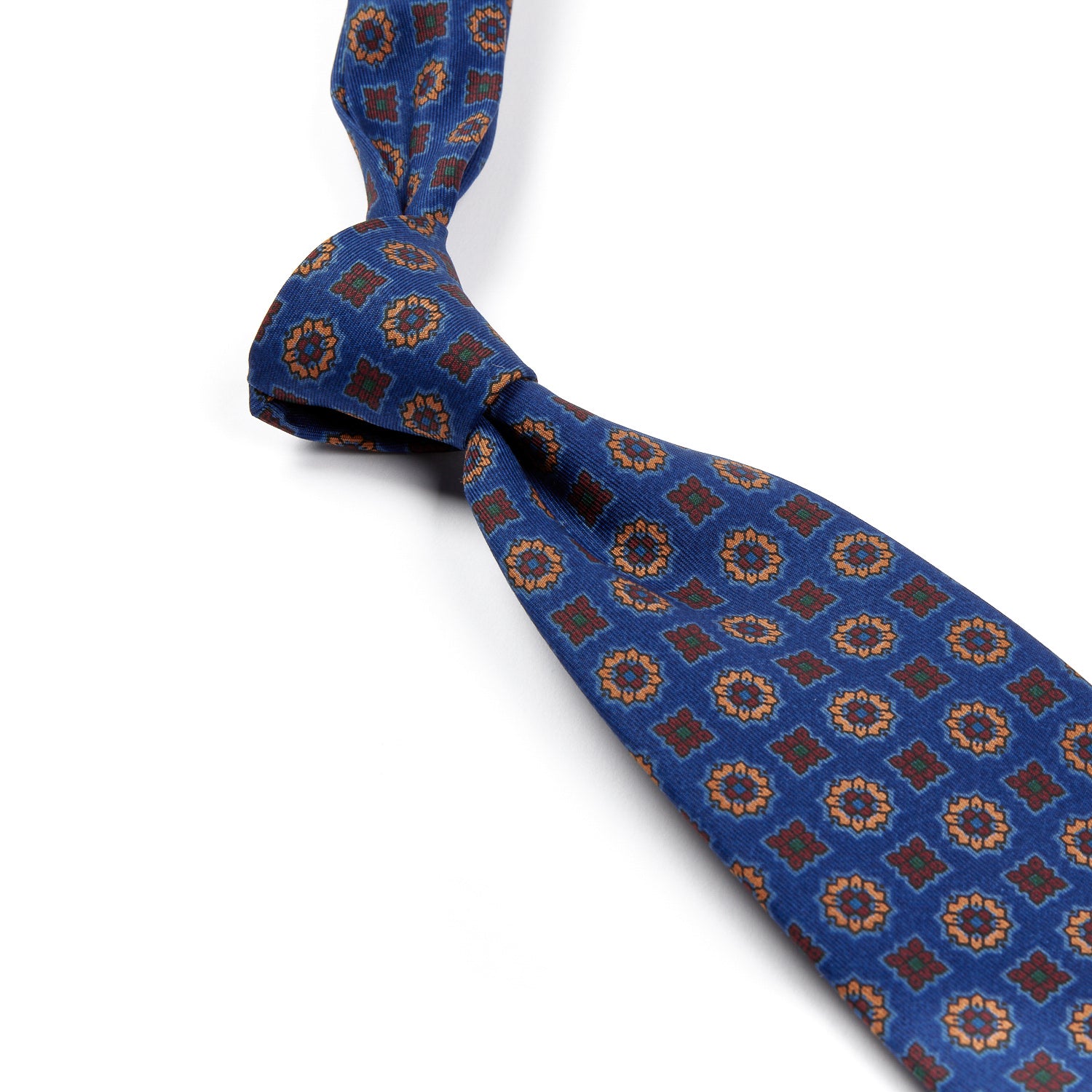 A high-quality Sovereign Grade Blue Floral Diamond Ancient Madder Tie with handmade brown and gold designs from KirbyAllison.com.