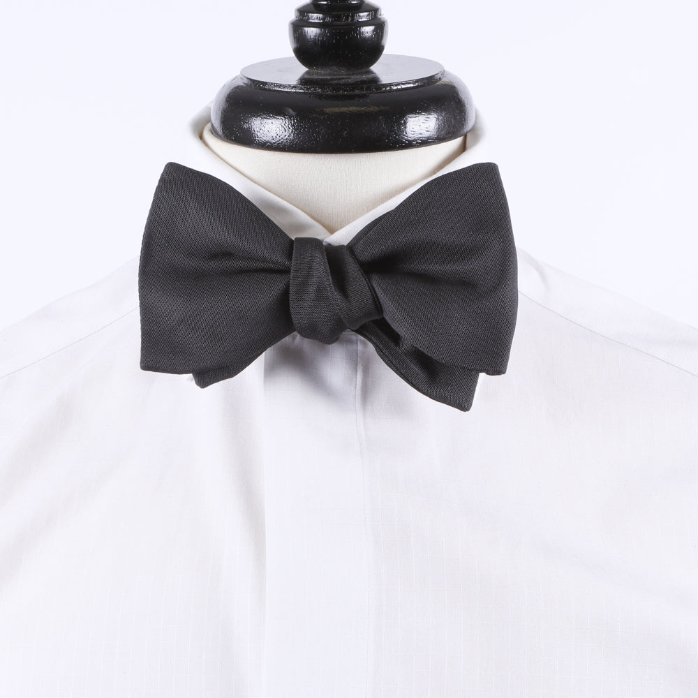 A Sovereign Grade Jumbo Barathea Butterfly Bow Tie from KirbyAllison.com displayed on a mannequin for a formal occasion.