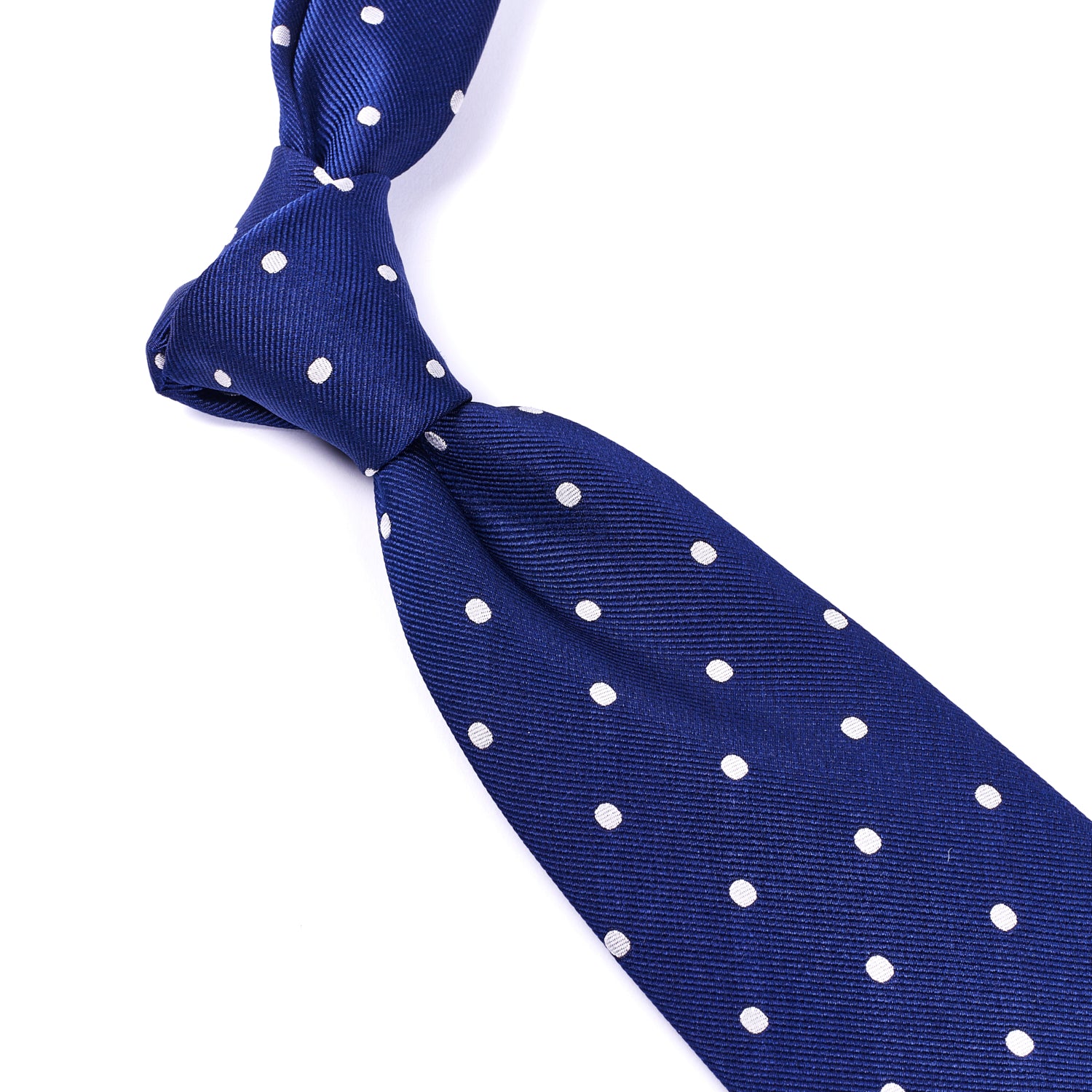A KirbyAllison.com Sovereign Grade Woven Navy/White Wide Dot Tie, 150 cm on a white background.
