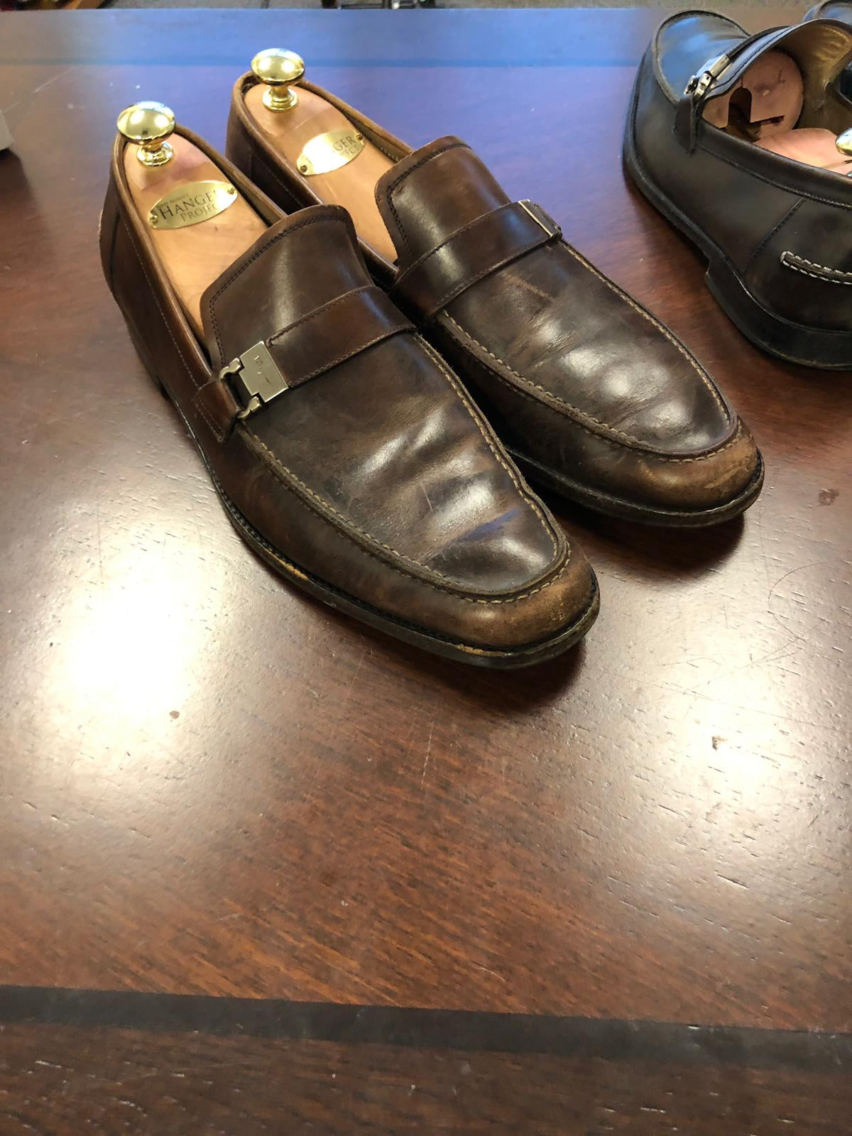 A pair of brown loafers on a table, showcasing the Presidential Shoe Shine Service by KirbyAllison.com.