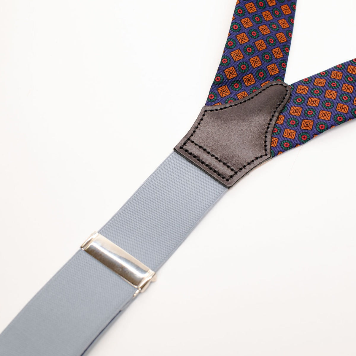Adjustable leather Sovereign Grade Solid Claret Braces with a blue and orange pattern, available at KirbyAllison.com.