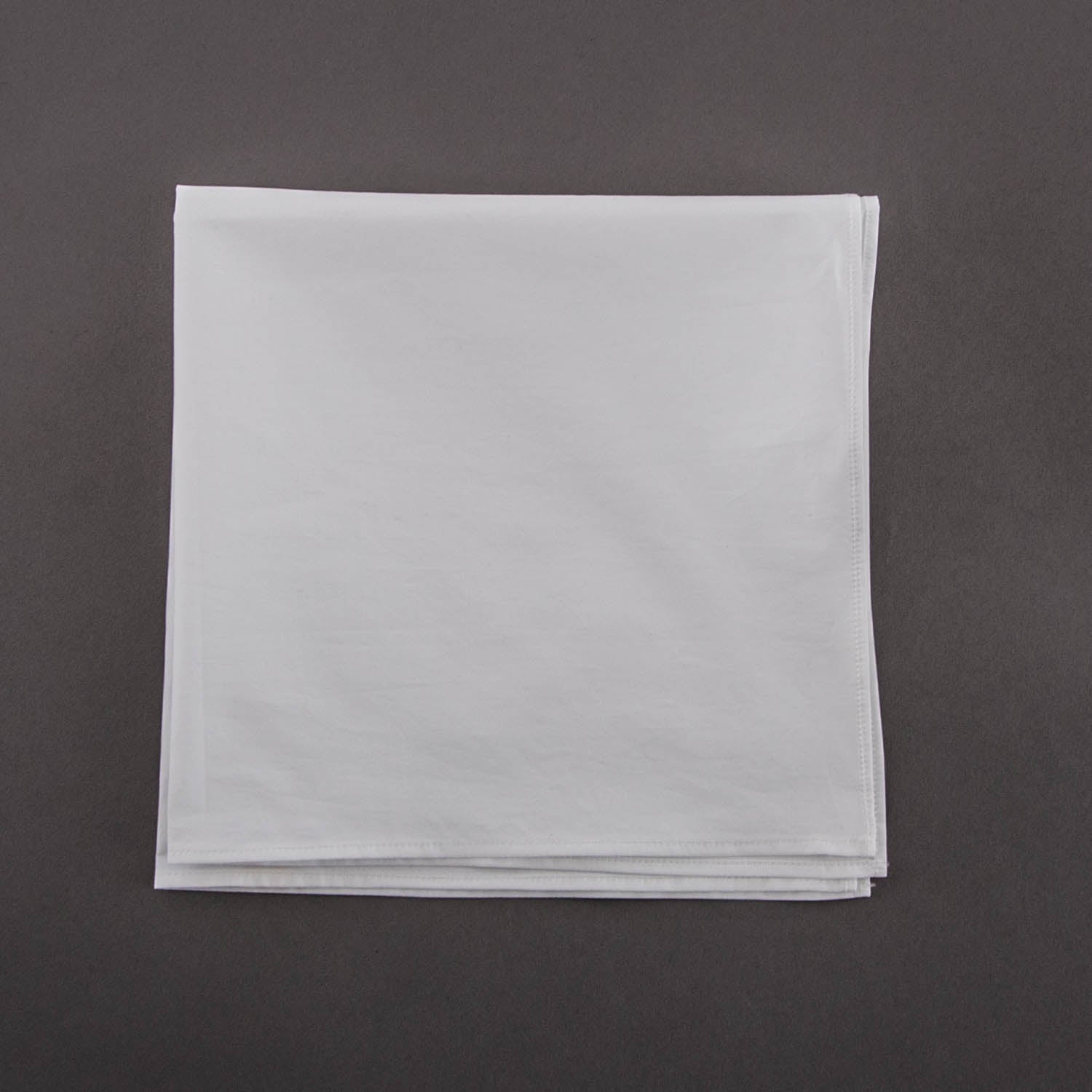 A Wellington High-Shine Cotton Chamois napkin on a grey background,
from KirbyAllison.com.