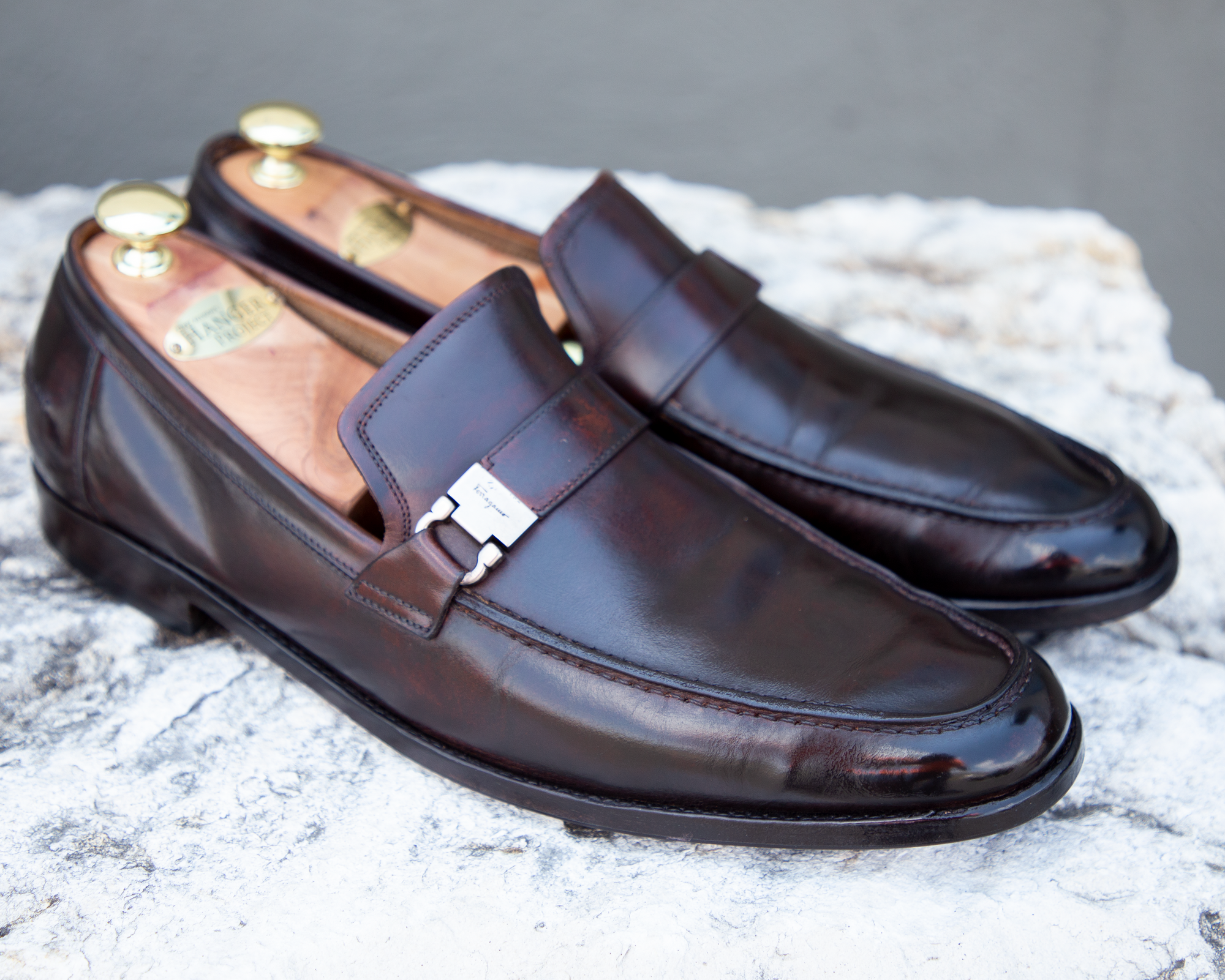 A pair of brown loafers on a rock, showcasing the Presidential Shoe Shine Service from KirbyAllison.com.