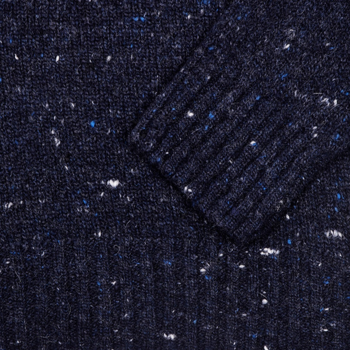 A close up of a Sovereign Grade Blue Donegal Crew Neck Sweater with blue and white speckles by KirbyAllison.com.