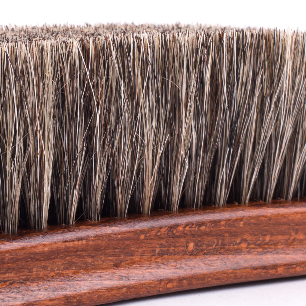 A Deluxe Wellington Horsehair Buffing Brush from KirbyAllison.com with a lot of horsehair on it.