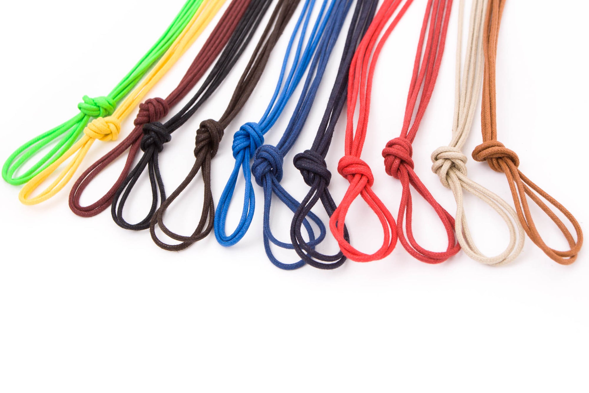 A group of Wellington Colored Round Waxed Shoelaces by KirbyAllison.com on a white background.