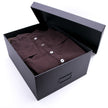 A brown Hanger Project Garment Storage Box from KirbyAllison.com with a brown shirt inside.