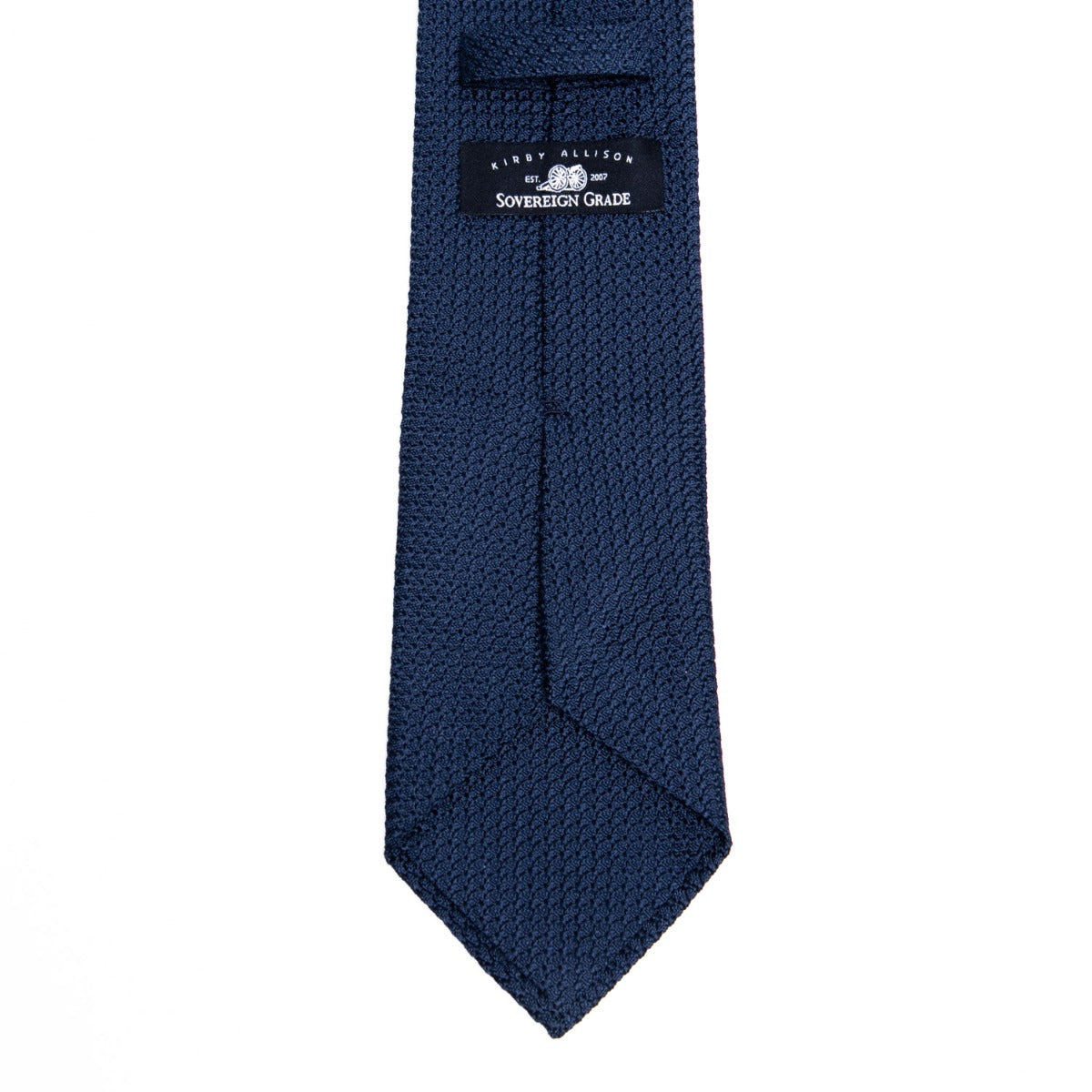A Sovereign Grade Grenadine Grossa Dark Navy Tie by KirbyAllison.com, of the highest quality, featuring a small logo.