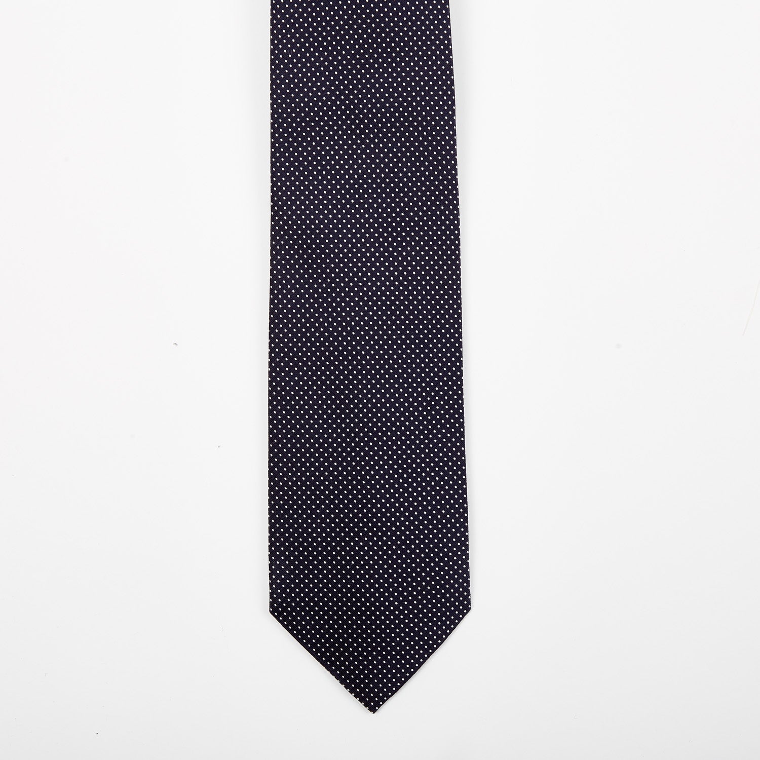 A Sovereign Grade Navy Silk Micro Dot Tie from KirbyAllison.com on a quality white background.