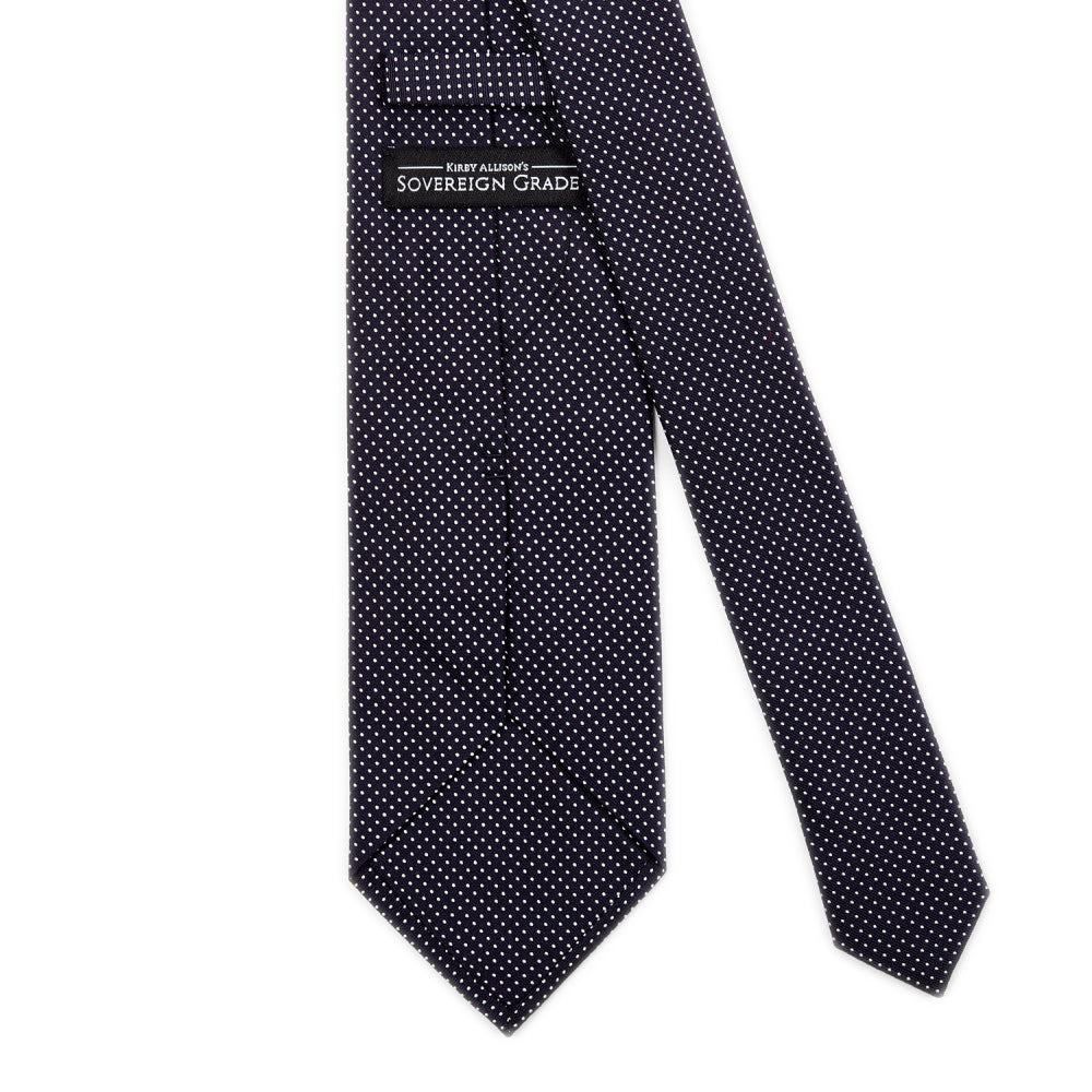 A Sovereign Grade Navy Silk Micro Dot Tie by KirbyAllison.com with a black and white polka dot pattern.