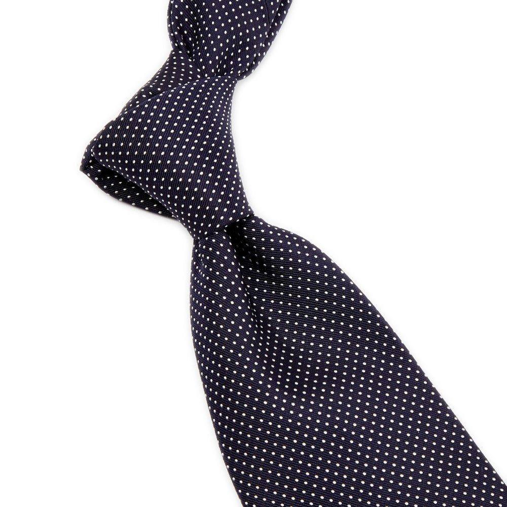 A handmade Sovereign Grade Navy Silk Micro Dot tie from KirbyAllison.com, representing quality from the United Kingdom.