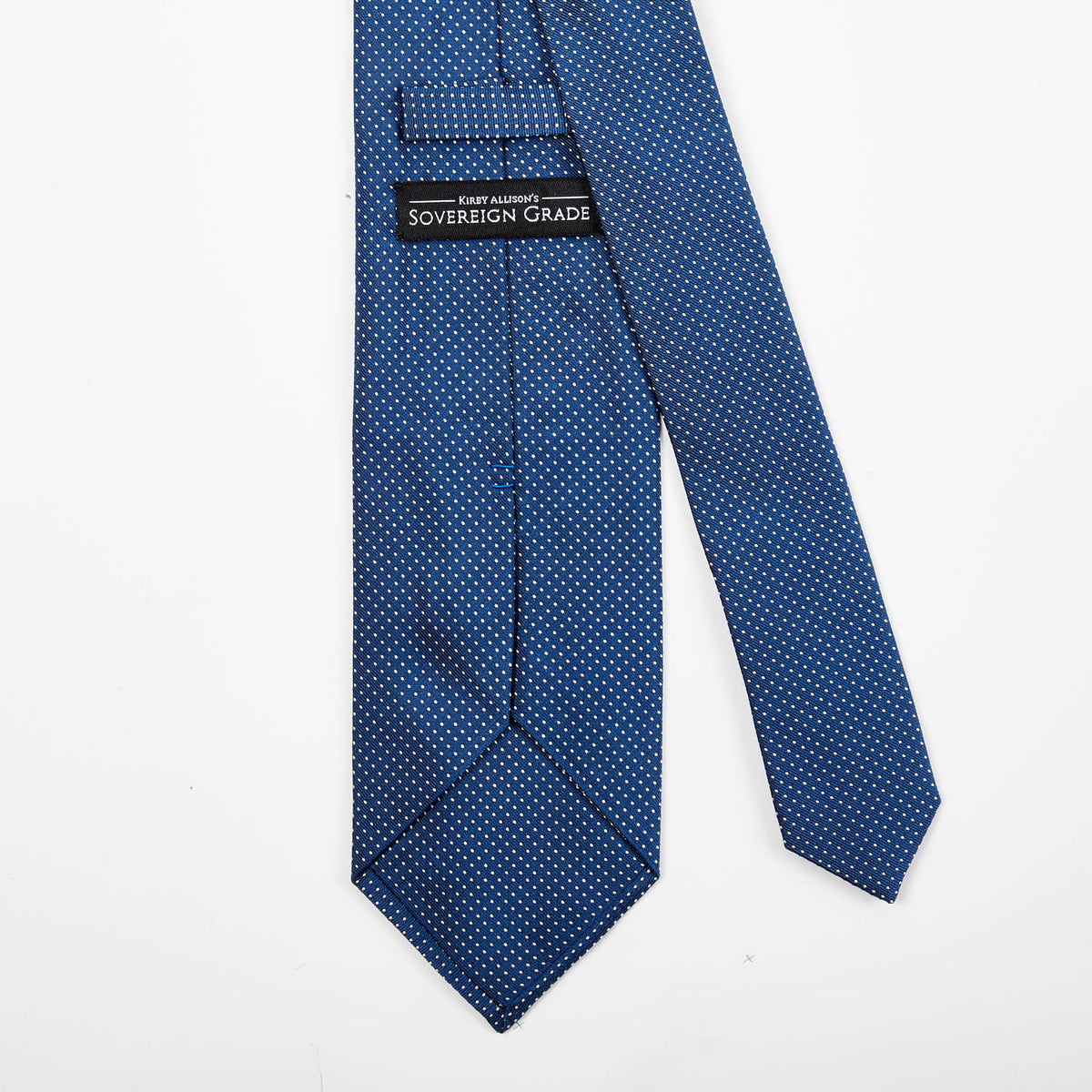 A handmade Sovereign Grade Blue Silk Micro Dot tie from KirbyAllison.com on a white background.