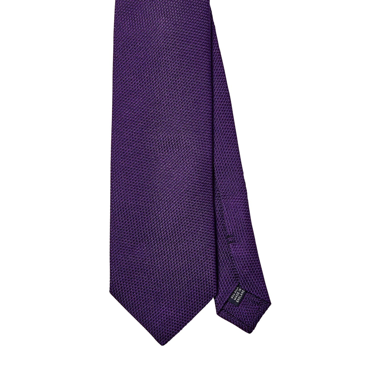A Sovereign Grade Grenadine Fina Purple Tie by KirbyAllison.com on a white background.