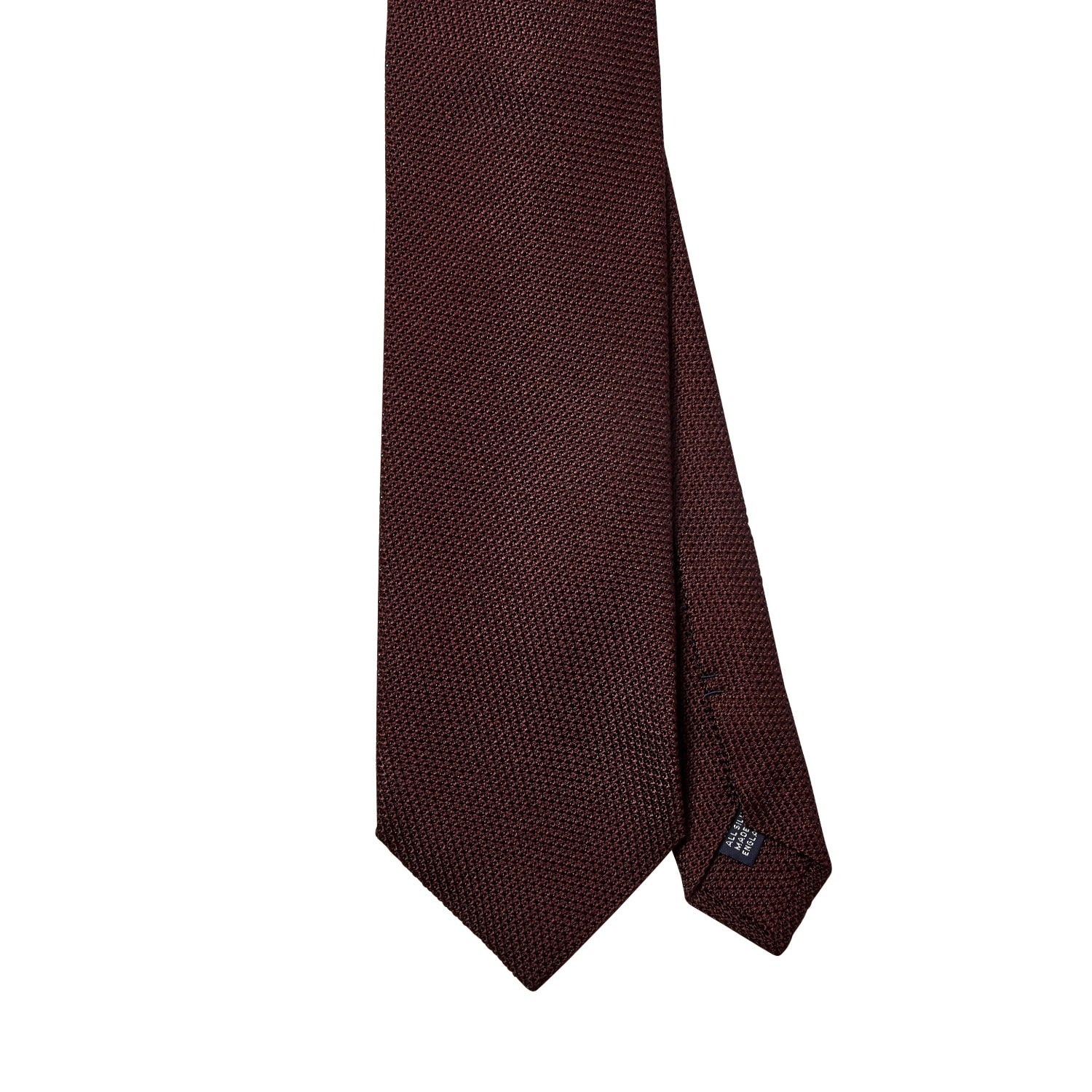 A Sovereign Grade Grenadine Fina Burgundy Tie by KirbyAllison.com on a white background, sourced from the United Kingdom.