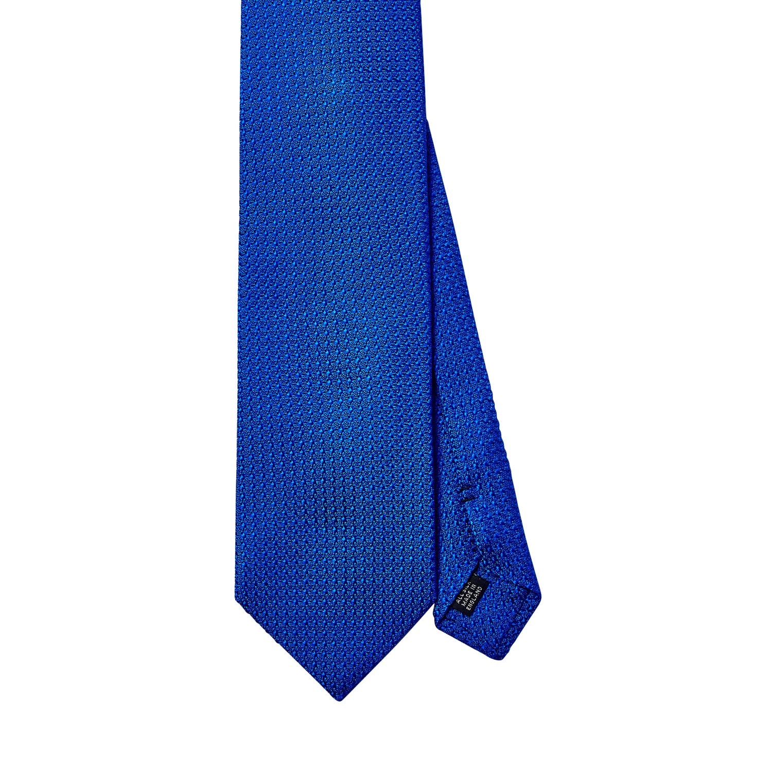 A handmade Sovereign Grade Bright Blue Grenadine Grossa tie on a white background, showcasing longevity and quality - KirbyAllison.com ties.