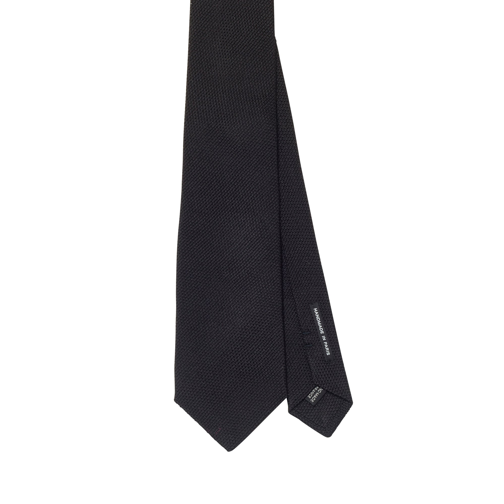 A Sovereign Grade Black Grenadine Fina Tie by KirbyAllison.com on a white background in the United Kingdom.