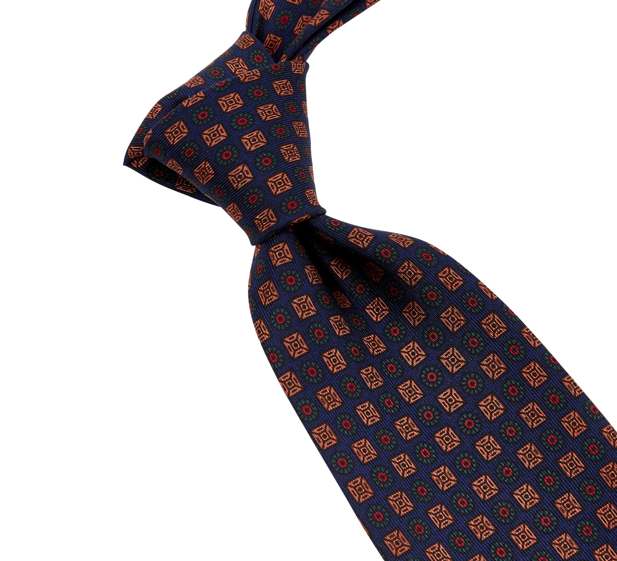 A high-quality, handmade Sovereign Grade Dark Navy Ancient Madder Tie with an orange and blue pattern, made in the United Kingdom by KirbyAllison.com.