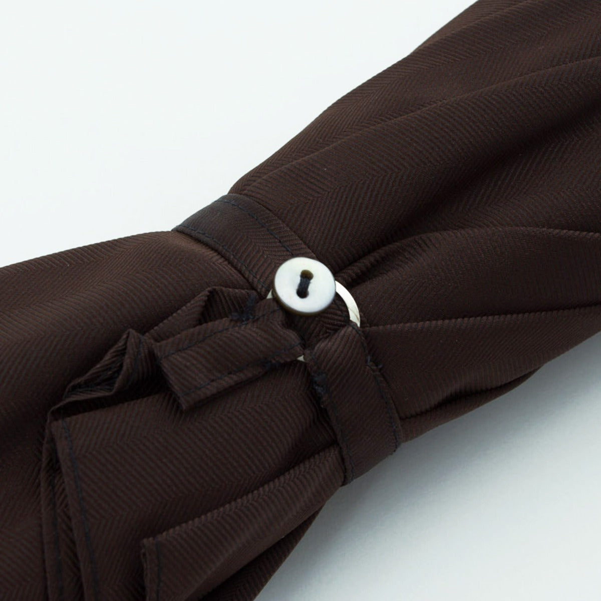 A KirbyAllison.com handcrafted Brown Herringbone Canopy Travel Umbrella Woven Leather Handle.
