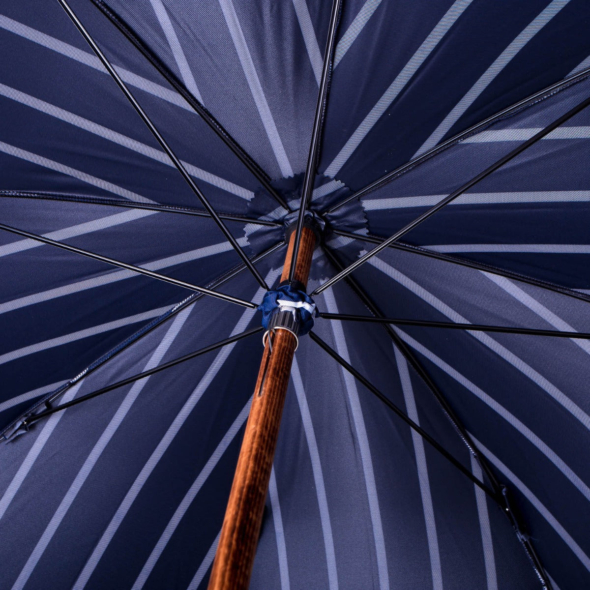 A KirbyAllison.com Navy Pin Stripe Umbrella with Bamboo Handle.