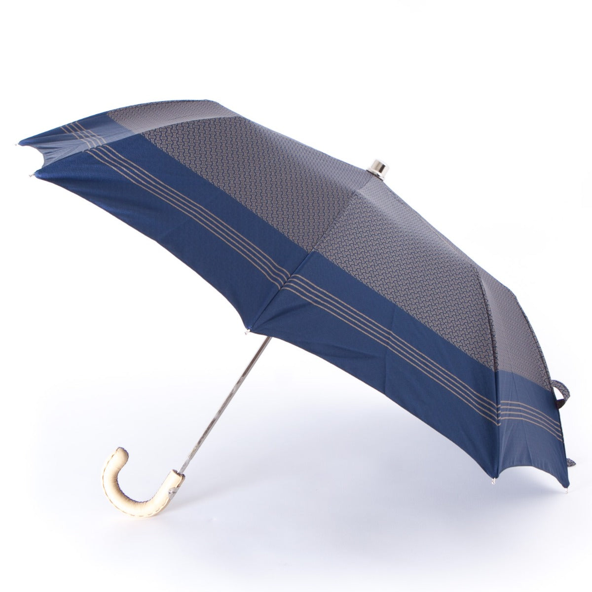 A Patterned Navy Travel Umbrella with Leather Handle by KirbyAllison.com, perfect for traveling in Milan, Italy.