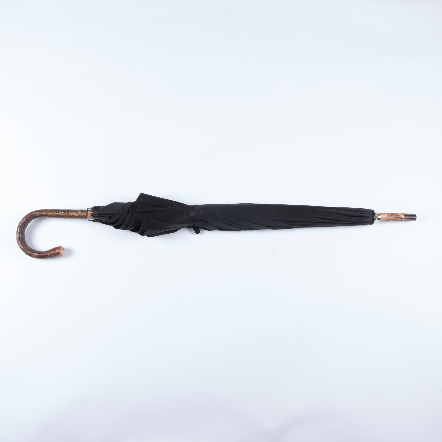 A Walnut Solid-Stick Umbrella with Black Canopy by KirbyAllison.com on a white background.