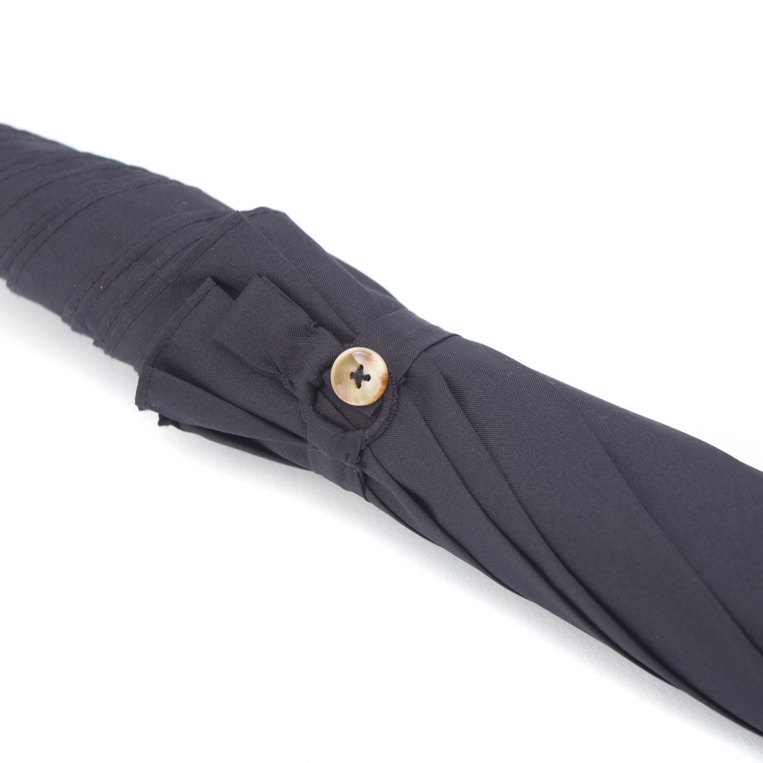 A Mario Talarico Black Canopy Umbrella with Dog Horn Handle from KirbyAllison.com, with a gold button on its canopy.