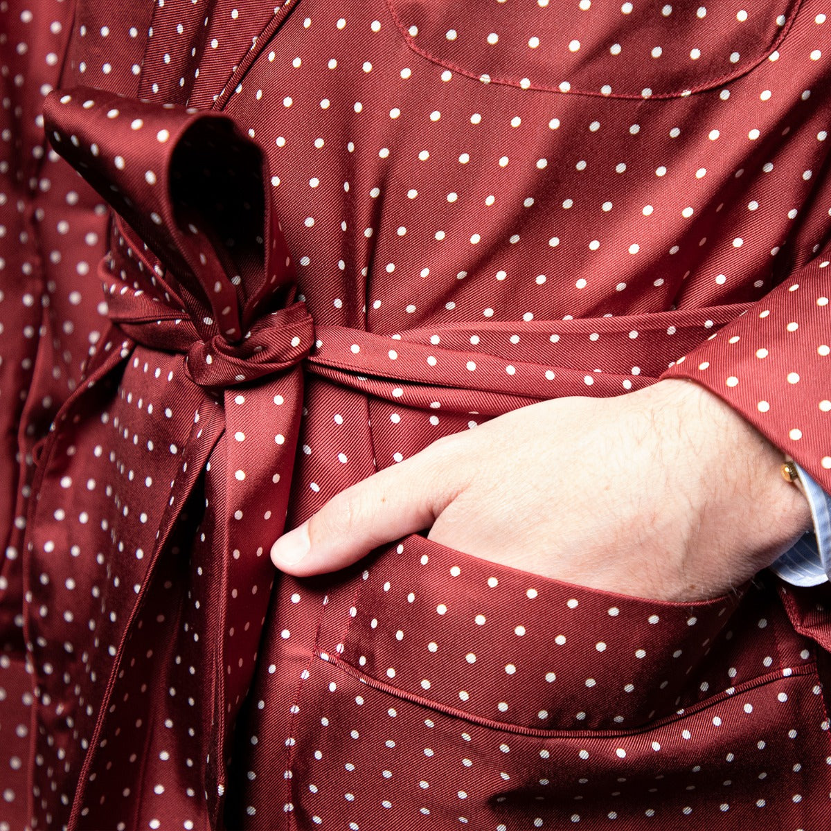 A man wearing a Sovereign Grade Burgundy London Dot Dressing Gown from KirbyAllison.com.