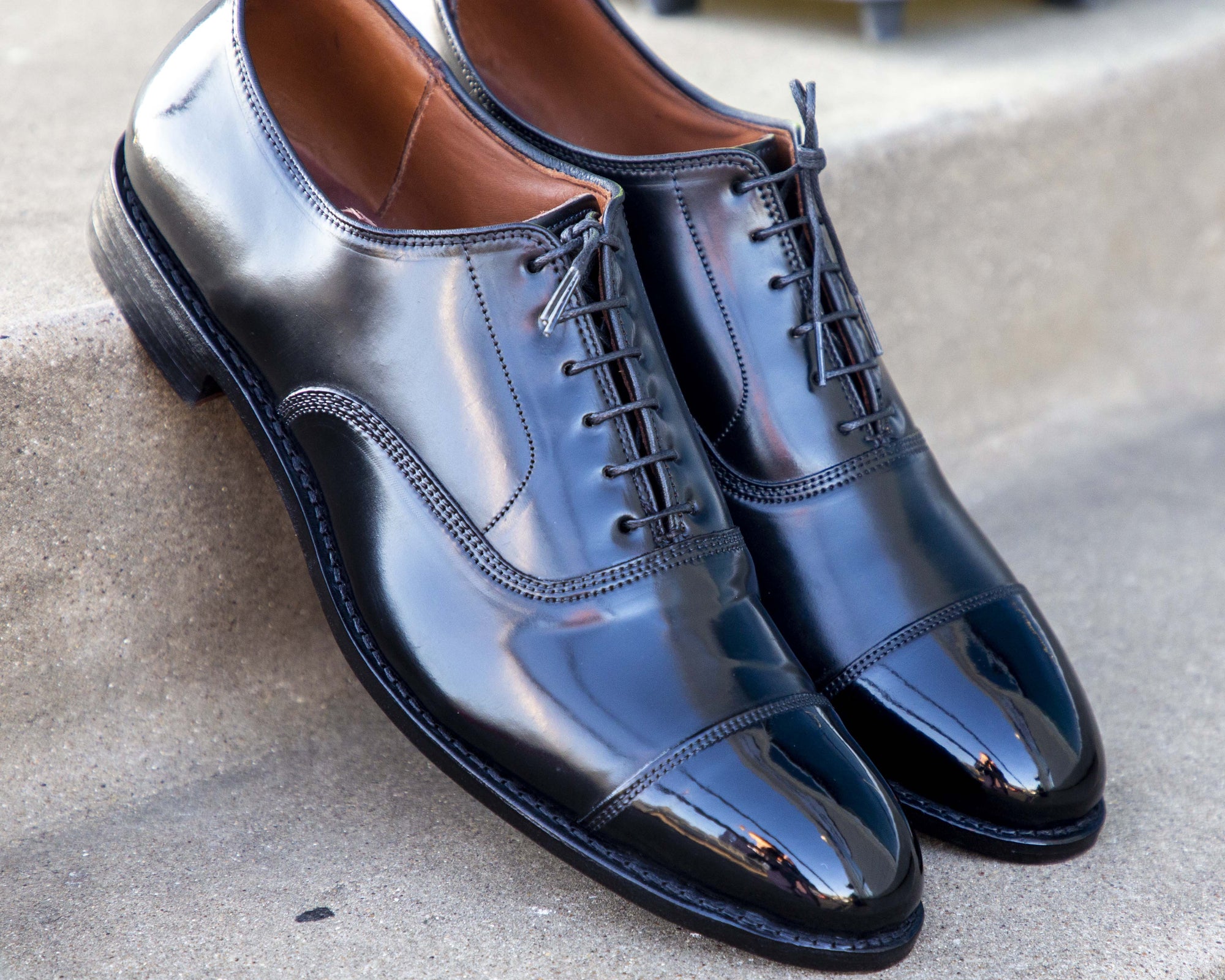A pair of black oxford shoes shining after a High Shine Service by KirbyAllison.com.