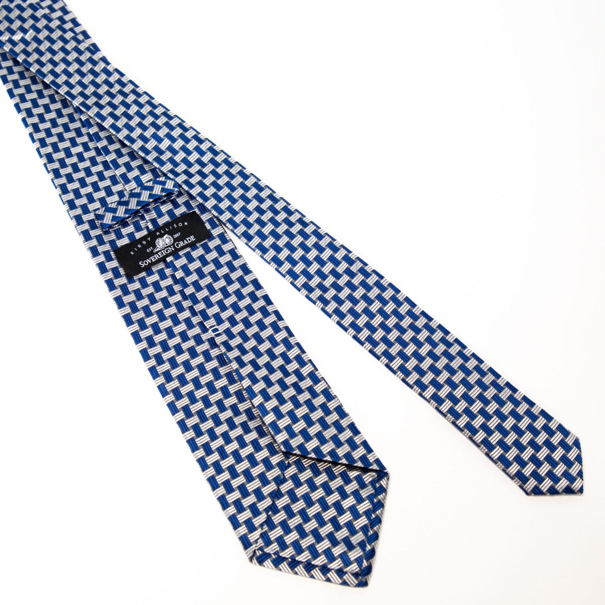 A Sovereign Grade Blue Basket Weave Silk Tie from KirbyAllison.com in a blue and white checkered pattern on a white surface.