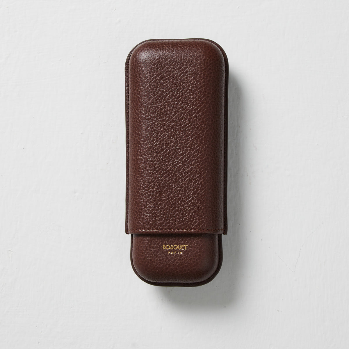 A Bosque Smooth Dark Brown Leather Cigar Case on a white surface.