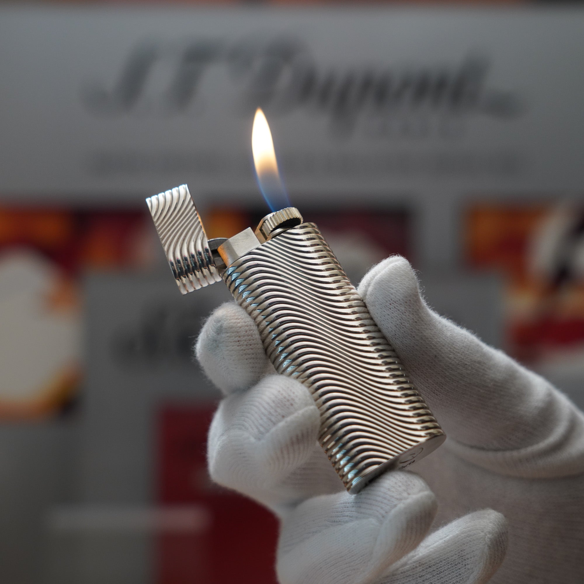 A person is holding a Vintage 1980 Cartier Solid Silver 925 Lighter Factory Argent in their hand.