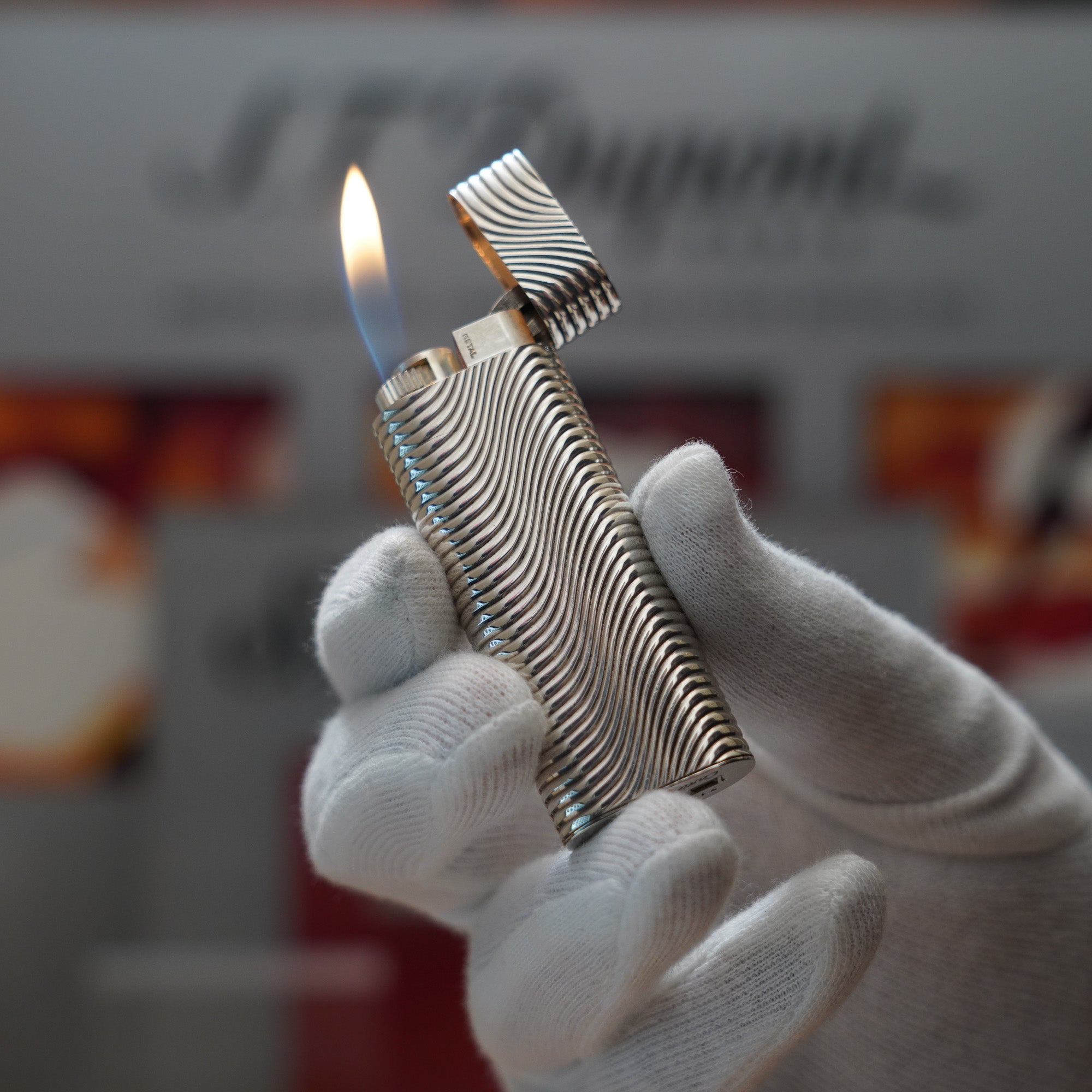 A person is holding up a Vintage 1980 Cartier Solid Silver 925 Lighter Factory Argent made of sterling silver.