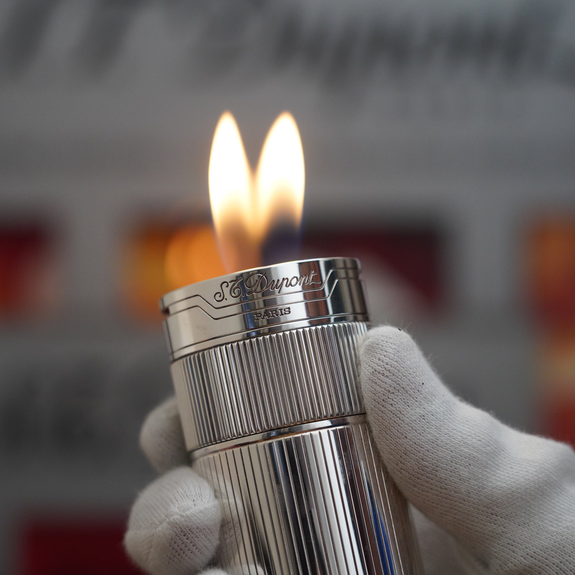 A Vintage 1980 S.T. Dupont Unique Dual Flame Cylinder Silver Plated Table Lighter with flames.