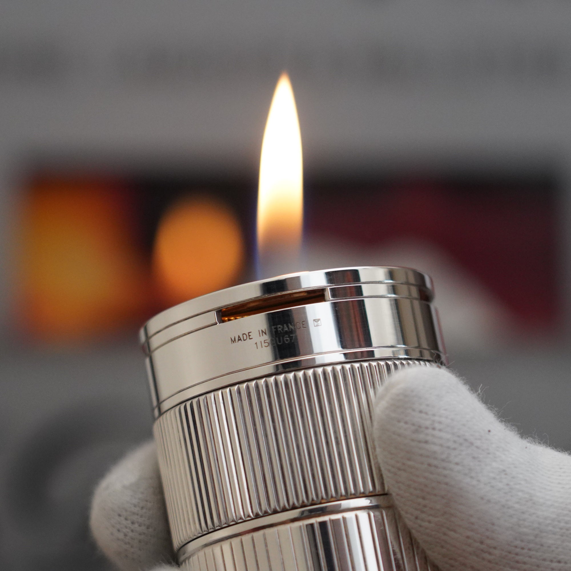 A person is holding a Vintage 1980 S.T. Dupont Unique Dual Flame Cylinder Silver Plated Table Lighter in their hand.