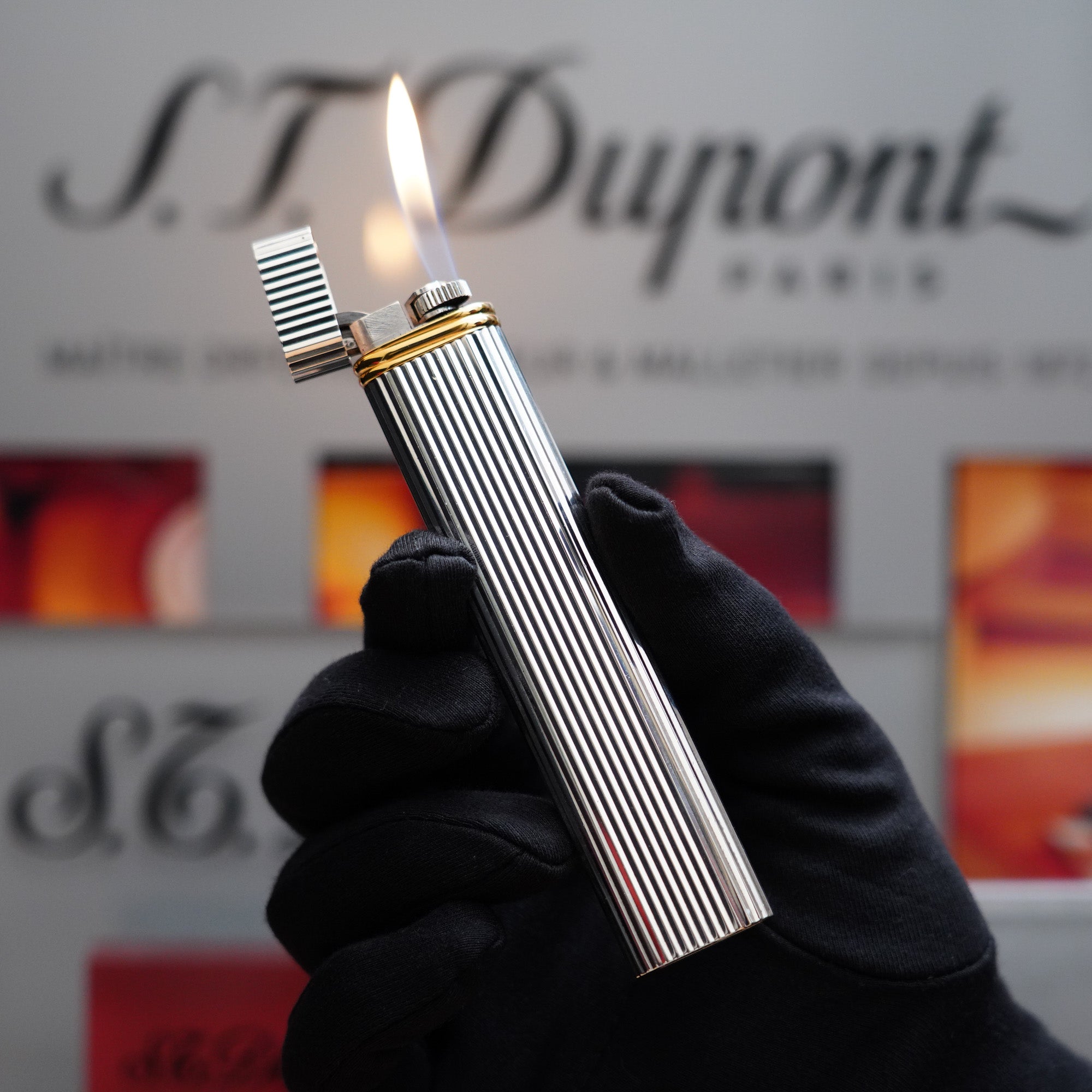 A vintage Cartier lighter featuring the brand ST Dupont.