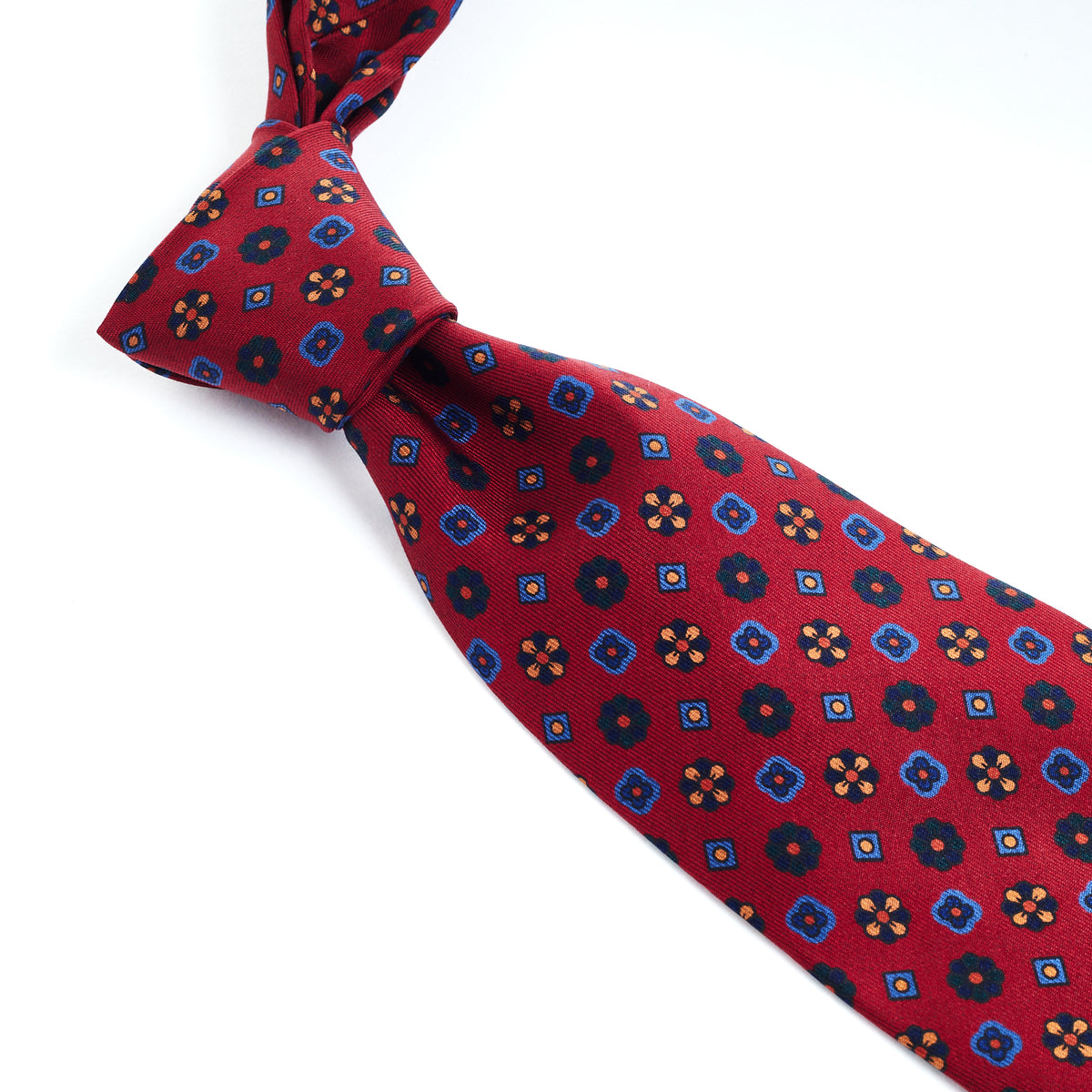 A Sovereign Grade Red Mixed Floret Ancient Madder Tie of exceptional craftsmanship with a blue and red pattern from KirbyAllison.com.