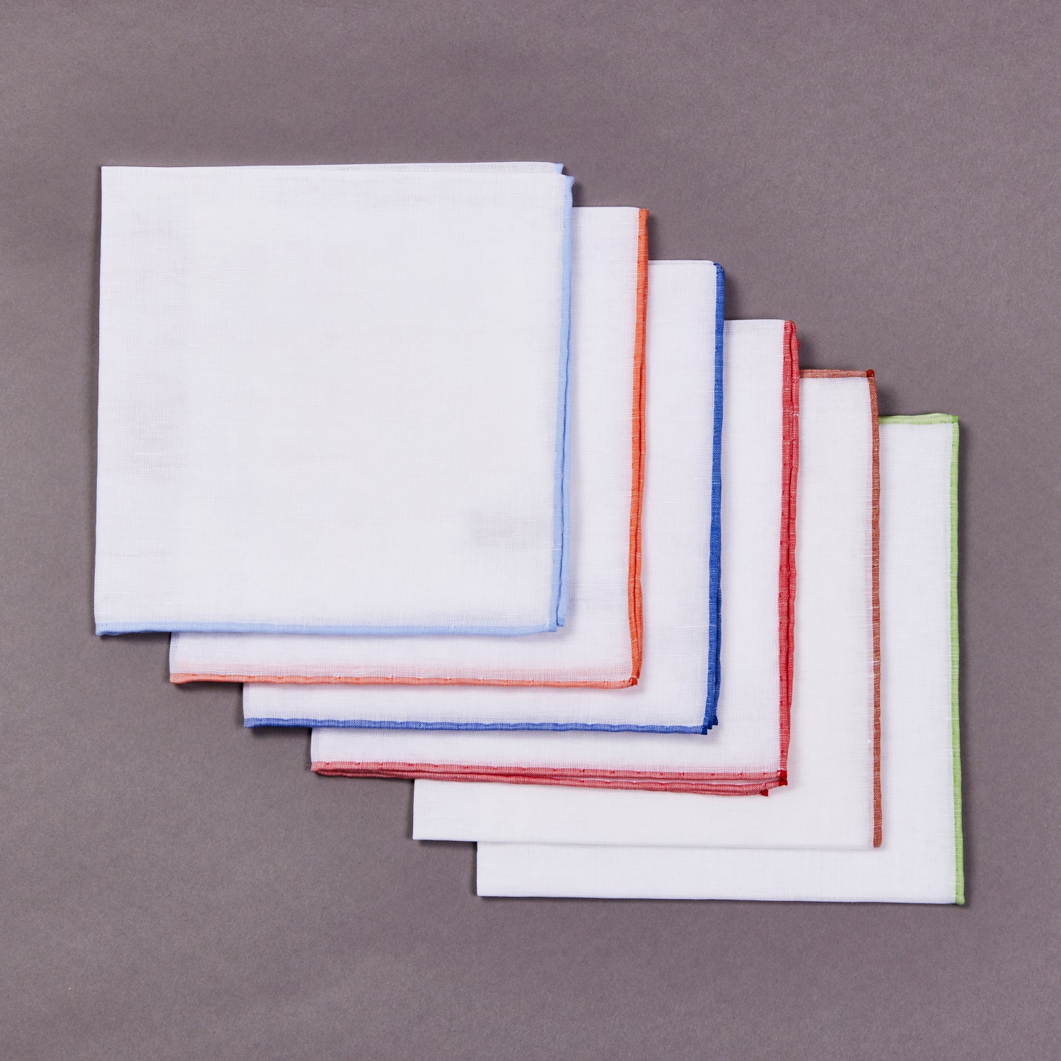A set of Simonnot Godard Benjamin Linen Pocket Square handkerchiefs from KirbyAllison.com on a gray background.