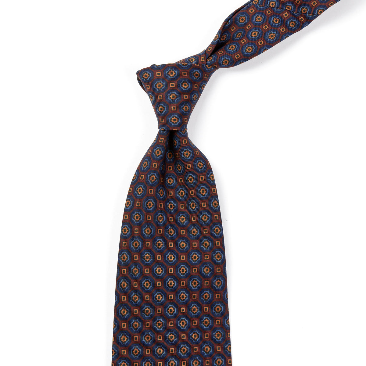 A Sovereign Grade Rust/Blue Floral Medallion Ancient Madder Tie, inspired by the colors of the United Kingdom, made by KirbyAllison.com.