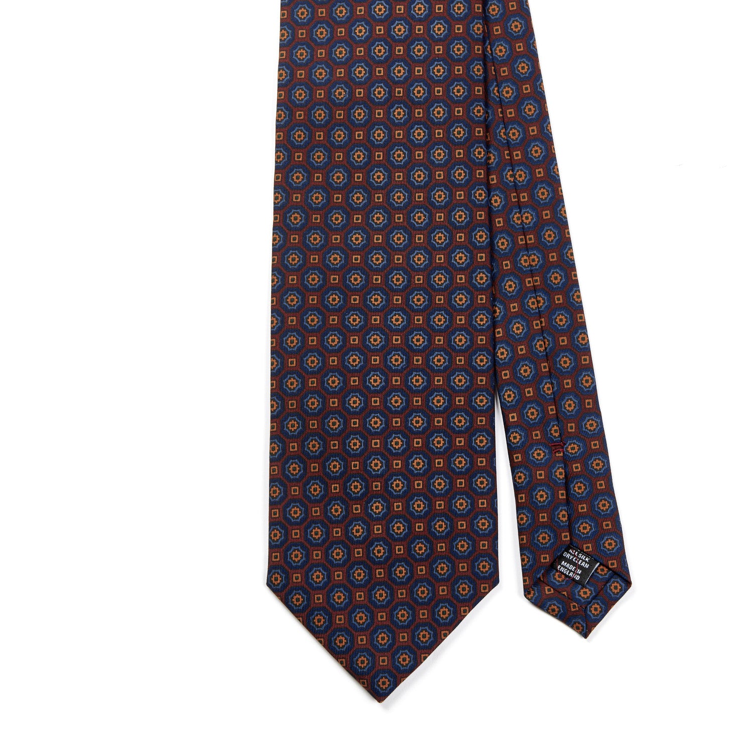 A handmade Sovereign Grade Rust/Blue Floral Medallion Ancient Madder Tie with a polka dot pattern in blue and orange, sold by KirbyAllison.com based in the United Kingdom.