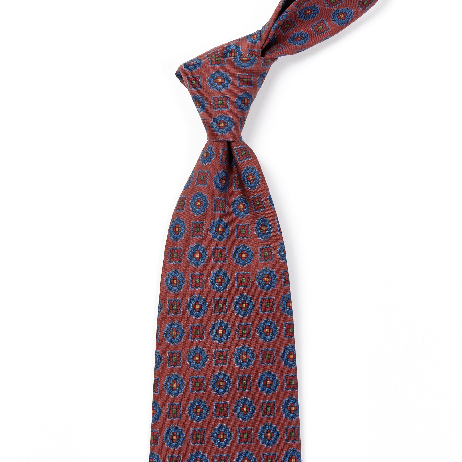 A handmade Sovereign Grade Rust Floral Diamond Ancient Madder tie with blue and red designs from KirbyAllison.com ties.