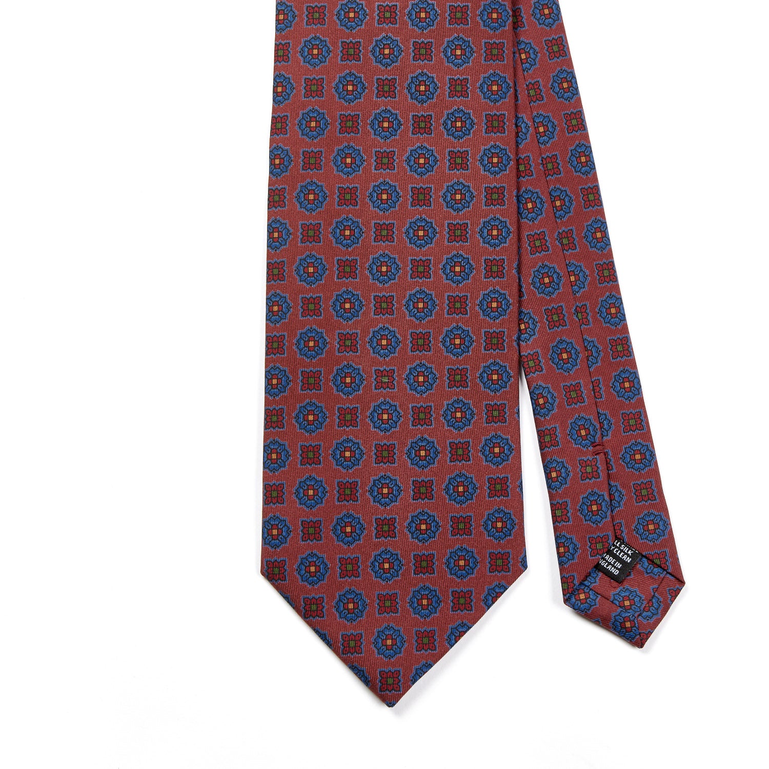 A Sovereign Grade Rust Floral Diamond Ancient Madder tie with blue and red circles on it, by KirbyAllison.com.