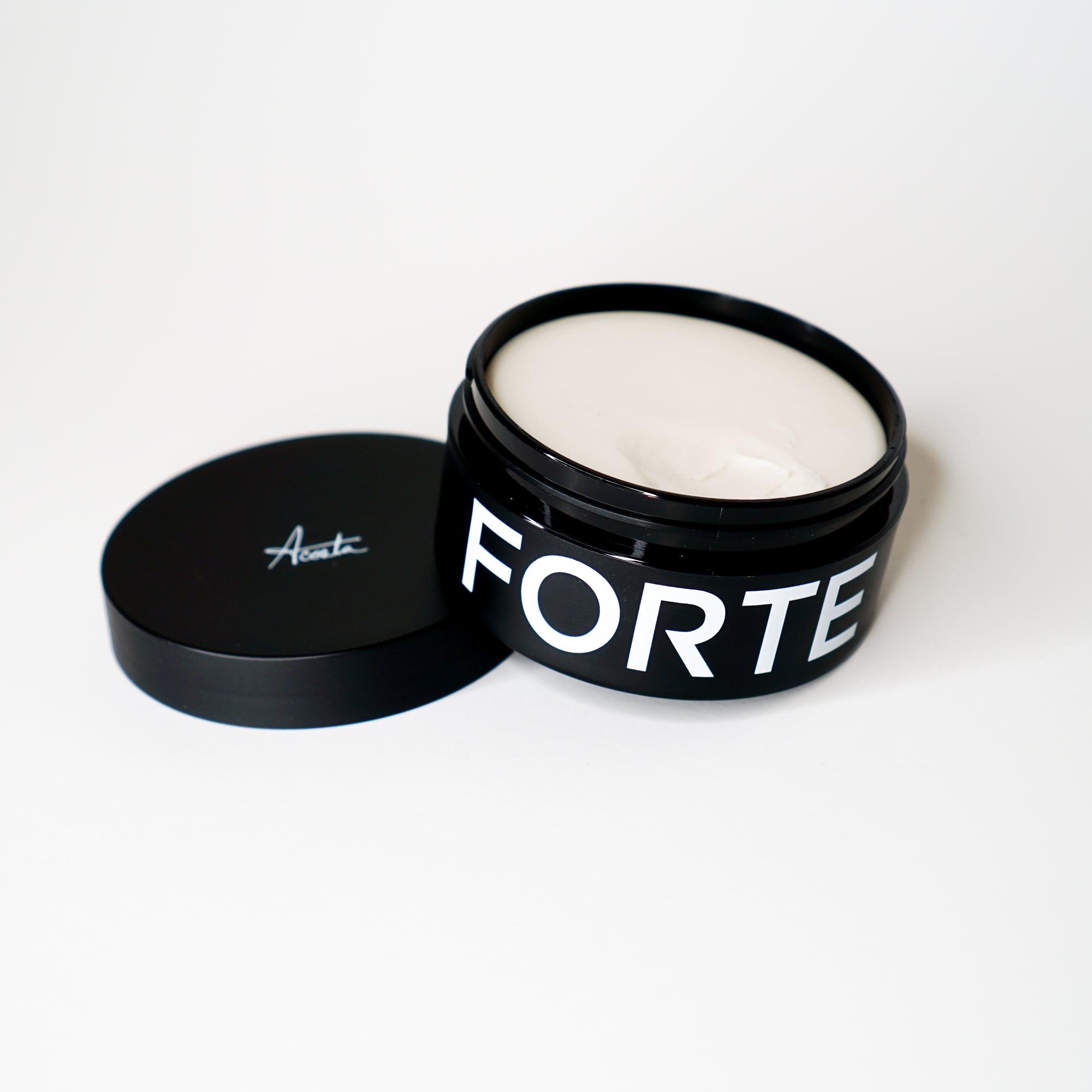 A tin with the word Forte Series Pomade on it, perfect for high volume hairstyles, made by KirbyAllison.com.