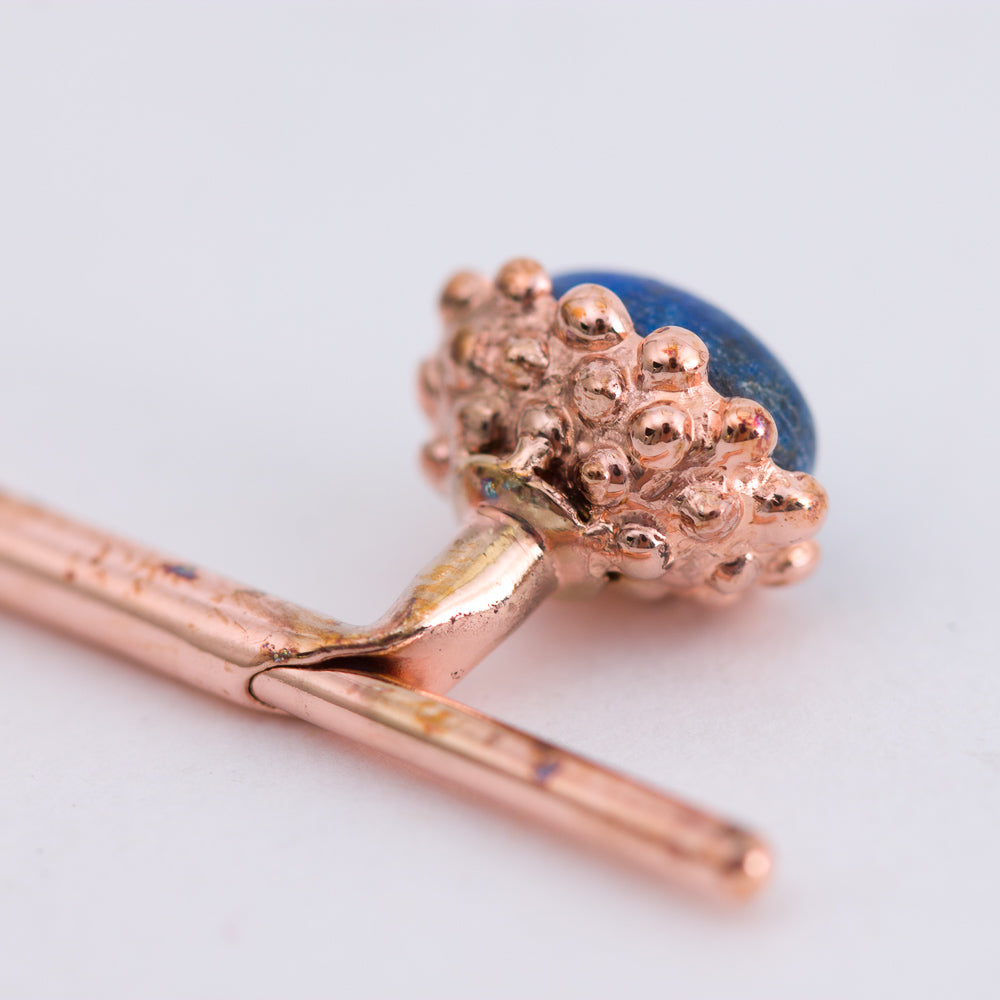 A rose gold earring with a Lapis Lazuli Golden Acorn Cufflinks by KirbyAllison.com.