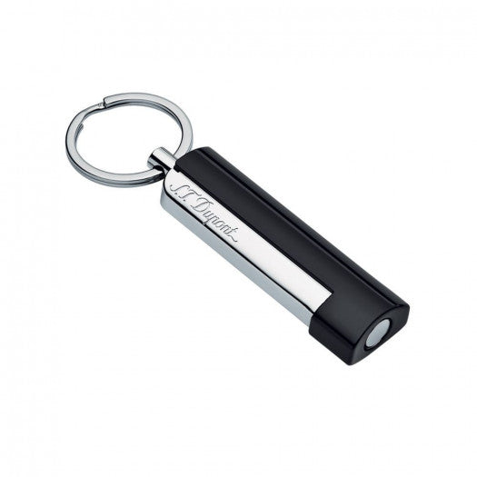 A black and silver S.T. Dupont key chain with a light on it, appropriate for cigar accessories.