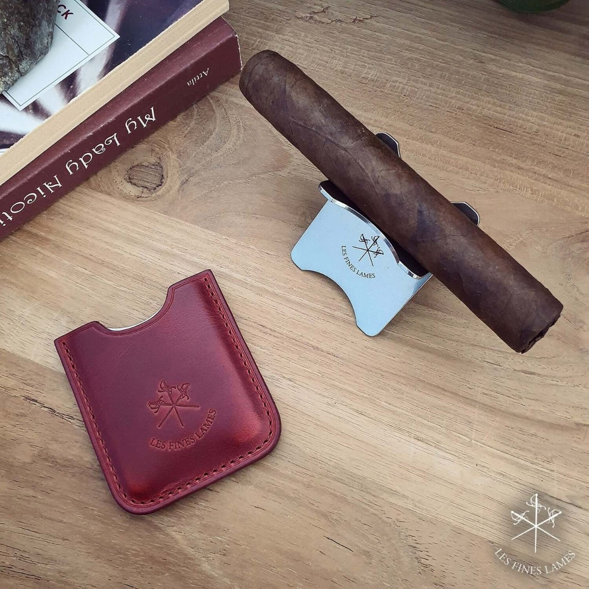 A cigar is displayed on a Kirby Allison Red Cigar Stand from KirbyAllison.com.